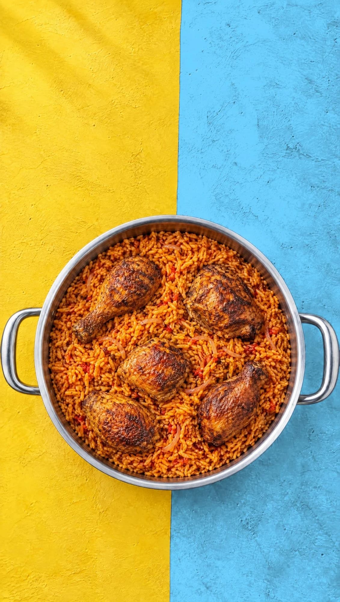 A pot of jollof rice with chicken, seen from above